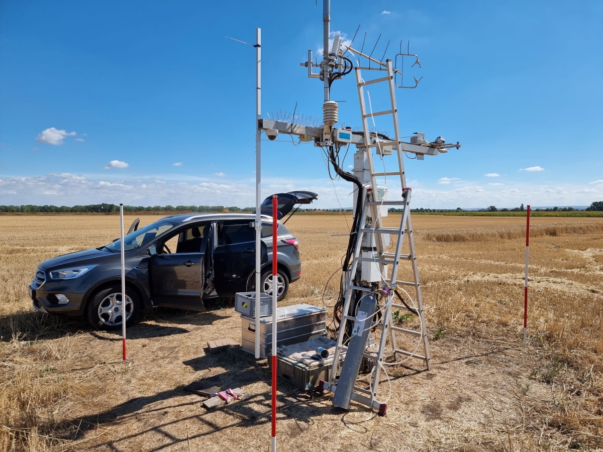 Instrument in field with car nearby