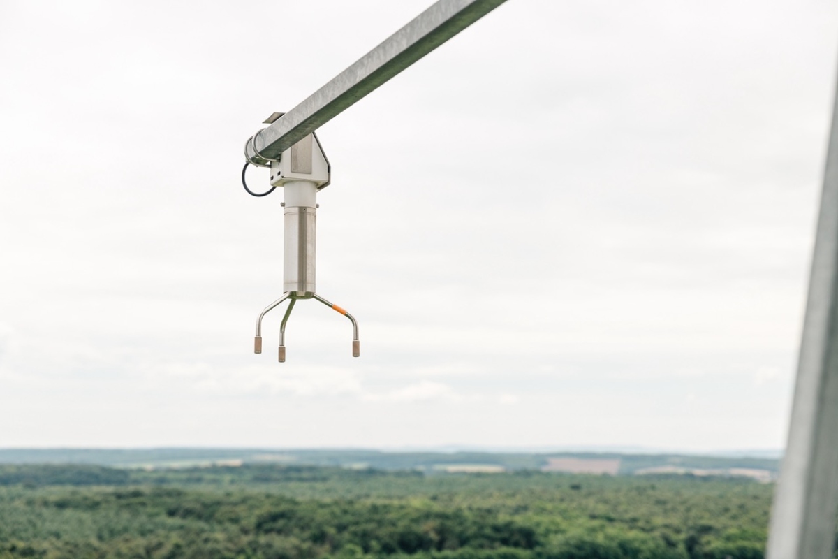 instrumentation on top of the tower with a rural landscape on the background