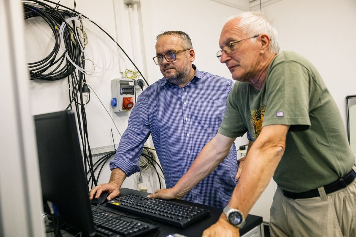 two scientists looking at screens